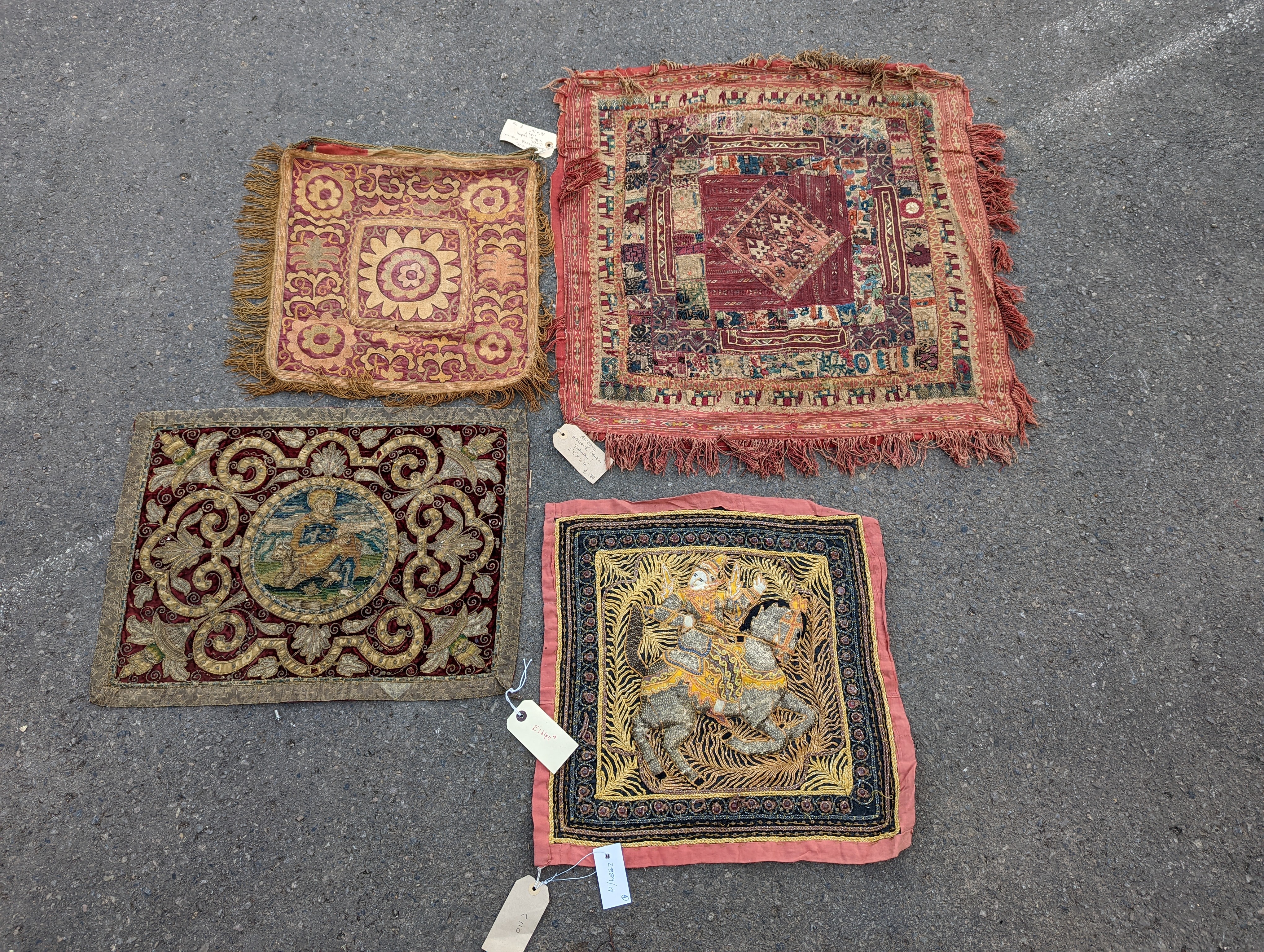 An Indian appliqué panel, two Indian appliqué covers and one other.